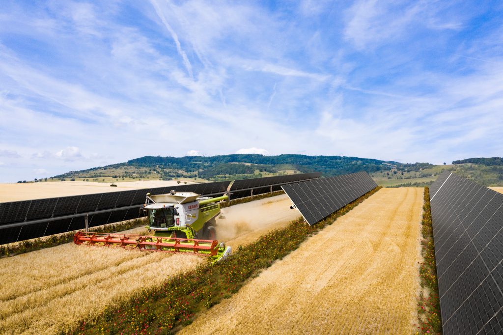 harvester tractor in field harvest with solar panels