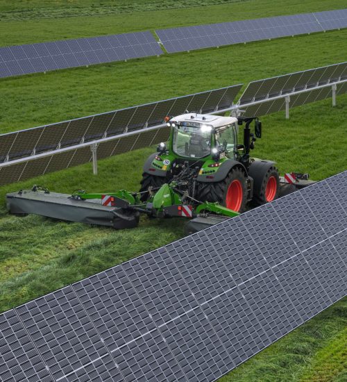 tractor in field with solar panels